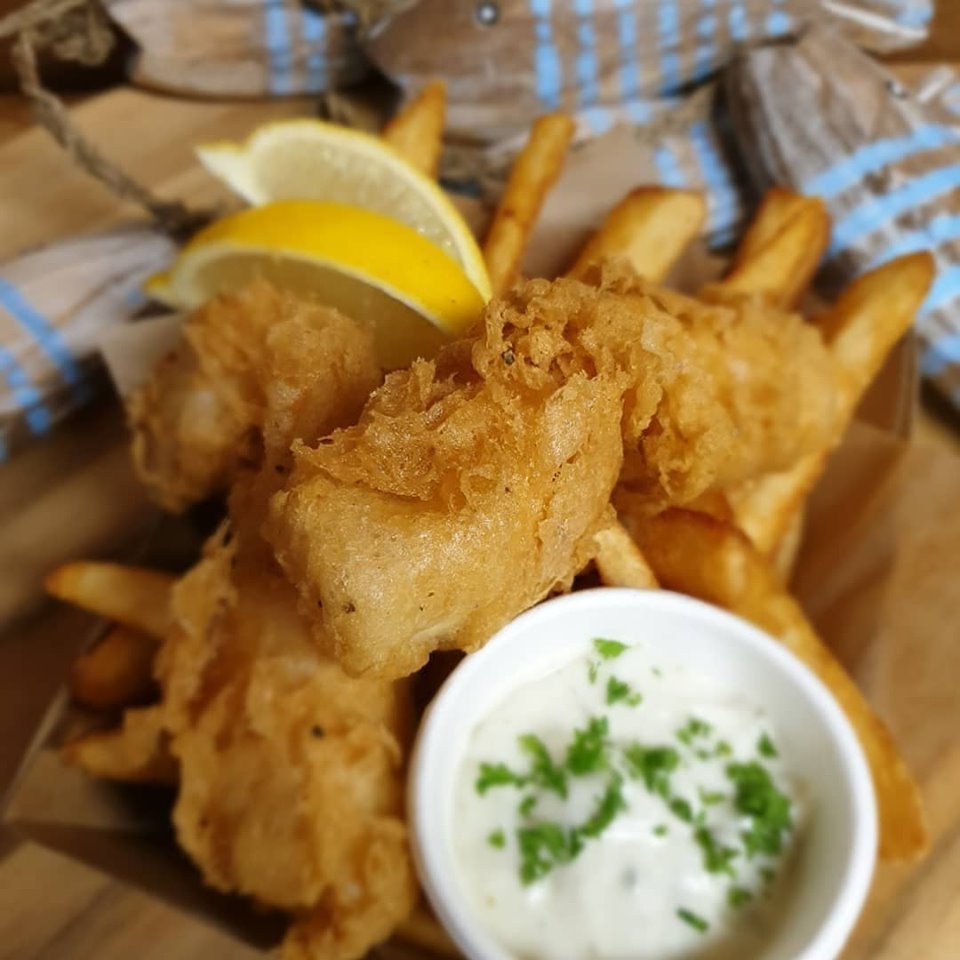 Golden battered fish and chips with lemon and tartare